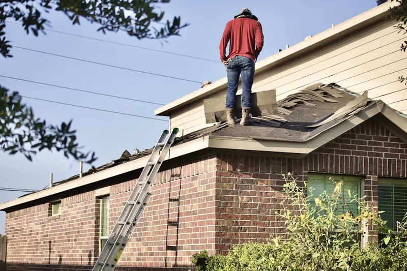 Professional roofer working on a residential roof in Bayou Blue